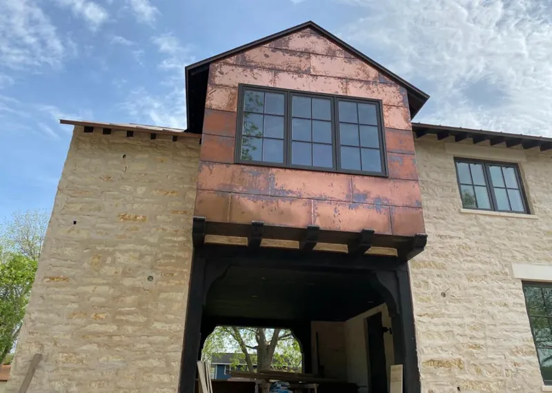 Copper metal panel facade on a stone building for Roof Repair in North Platte